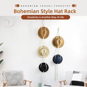 Detail of bohemian cotton rope hat organizer with tassels on white wall interior