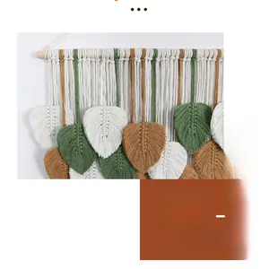 Detailed close-up of handmade woven cotton leaf tapestry on a wooden hanging pole