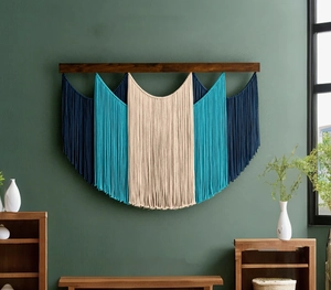 Macro detail of three-tone hand-woven macrame wall hanging with layered cotton tassels