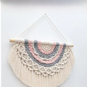 Detailed macro view of multi-color bohemian macrame wall hanging with cotton fringe
