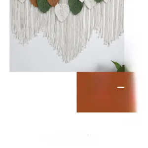Detailed macro view of bohemian hand-woven wall hanging with colorful leaf tassels