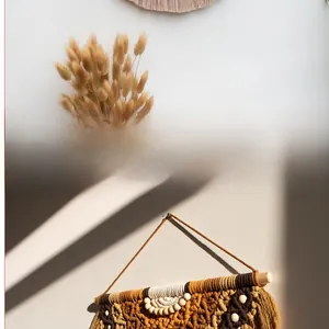 Detail of bohemian macrame wall hanging with wooden beads and colorful cotton tassels
