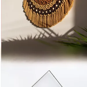 Detail of bohemian woven tapestry with ginger cotton ropes, wood beads, and fringe tassels