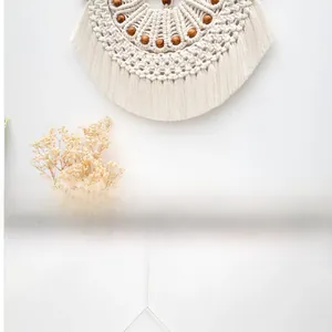 Close-up of macrame wall hanging featuring handcrafted cotton ropes and wooden beads