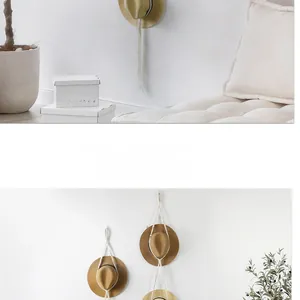 Detail showing handwoven cotton rope hat organizer in a minimalist bohemian style