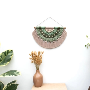 Handmade bohemian macrame wall hanging with green cotton ropes and wooden beads