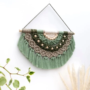Bohemian woven macrame wall hanging with green cotton ropes and wood branch base