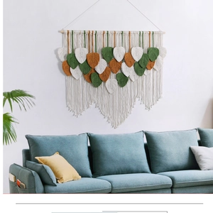 Detail of bohemian macrame wall hanging with multilayered colorful woven leaf patterns