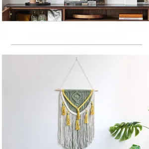 Detail of bohemian handmade woven tapestry with green and beige cotton fringe and wood bar