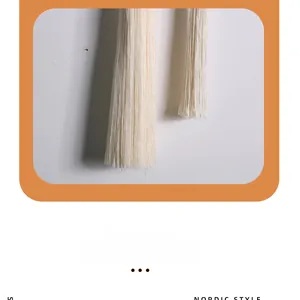 Detail of Nordic style hand-woven cotton fringe with intricate ivory tassel textures