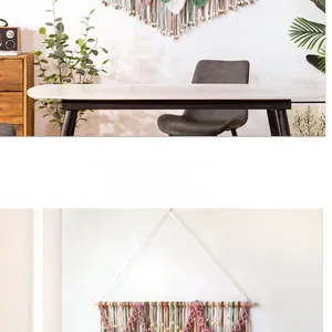 Detail of bohemian handmade woven wall hanging featuring colorful cotton ropes and wood beads