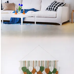 Detail of handcrafted macrame leaf wall hanging with cotton rope and wood pole