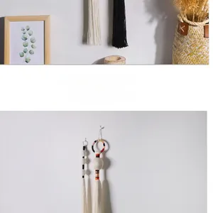 Close-up of bohemian hand-woven cotton tassels and spheres for nordic home wall decor