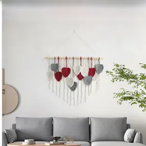 Detail of Bohemian hand-woven leaf macrame wall hanging in grey, beige and red tones