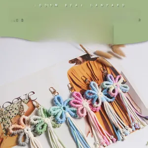 Detail of boho woven flower keychains with wooden beads and tassels in various colors