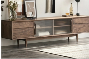 Detail of walnut sideboard with fluted glass sliding door and smooth wooden drawers