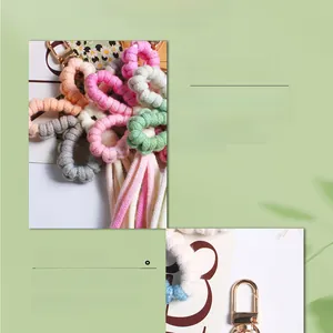 Close-up of handmade woven flower keychains with metallic lobster clasps and soft textures