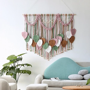 Handmade macrame wall hanging with colorful feather leaves for boho home wall decor