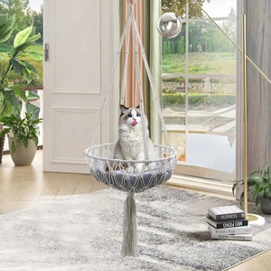 Detail of handcrafted macrame cat hammock featuring white cotton rope and a soft grey cushion
