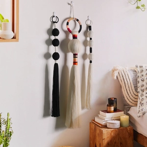 Set of three handcrafted boho tassels with woven spheres and long fringe wall decor