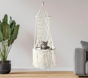 Detail of hand-woven cotton rope cat hammock featuring fringe trim and soft cushion