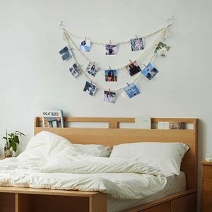 Bohemian woven wall hanging with wooden clips and white cotton ropes for photo display