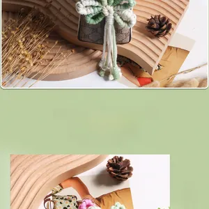 Detail of handmade crochet flower keychain with green fringe and elegant white pearls