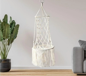 Detail of handmade bohemian macrame cat hammock with woven cotton rope and elegant tassels