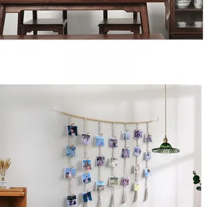 Detail of hand-woven cotton rope photo wall hanging with wooden clips and tassels