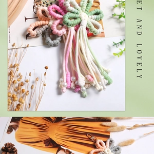Detail of handmade woven flower keychain with pastel tassels and faux pearl charms