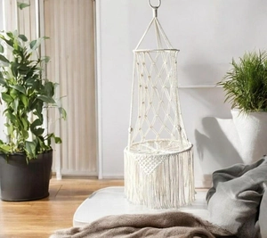 Detailed view of bohemian handwoven cotton rope cat hammock with decorative fringes