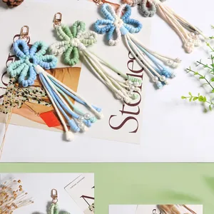 Detail of handmade crochet flower pendant with soft tassels and pearls for bags