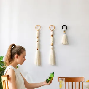 Three-piece set of woven macrame wall hangings with wood rings and cotton tassels
