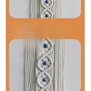 Close-up of bohemian hand-woven cotton macrame with a blue evil eye bead detail