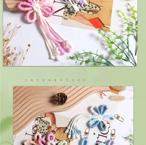 Detailed macro view of handmade macrame flower charm with fringe and gold lobster clasp