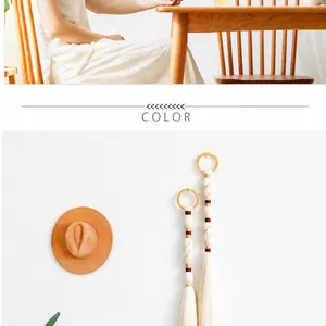 Detail of bohemian handmade cotton rope wall hanging with tassel and wood ring decor