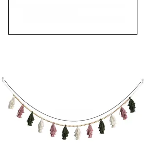 Detail of 150cm wood bead garland with colorful cotton tassels for boho wall decor