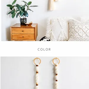 Detail of bohemian hand-woven cotton rope and wooden ring for wall decor tassels