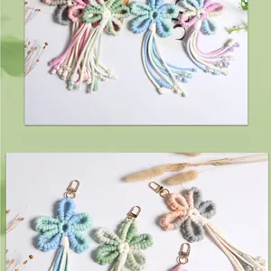 Detailed close-up of handmade woven flower keychain with soft tassels and white pearls