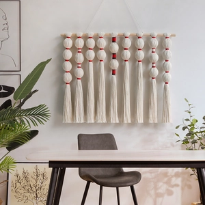 Bohemian handmade woven wall hanging with cotton tassels and round balls on wood pole