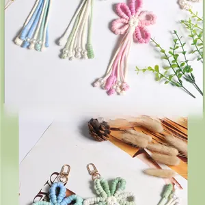 Macro shot of handmade woven flower keychains with metal clasps and pearl beads