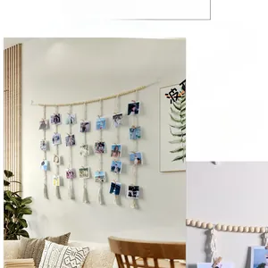 Detail of bohemian woven wall photo display with wooden beads, macrame fringe and clips