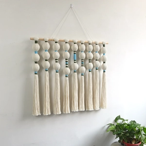 Bohemian handmade woven wall hanging with cotton ball tassels and wooden rod decoration