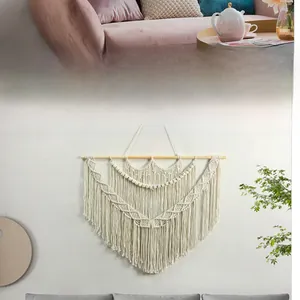 Detailed close-up of Bohemian hand-woven cotton tapestry with geometric fringe patterns