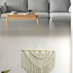 Close-up of bohemian macrame wall hanging featuring handcrafted cotton weave and long tassels