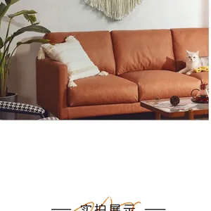 Detail of caramel leather triple sofa with bohemian cushions and modern home decor