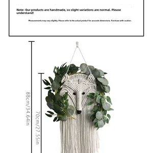 Detail of fox-shaped macrame wall hanging with eucalyptus leaves and long cotton tassels