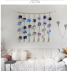 Detail of macrame wall hanging with wooden clips and beads for photo display