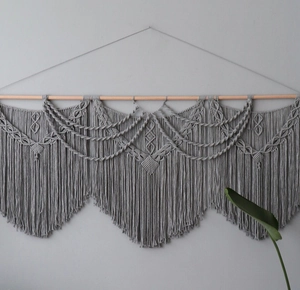 Close-up of Bohemian handmade woven cotton tapestry with intricate diamond fringe details