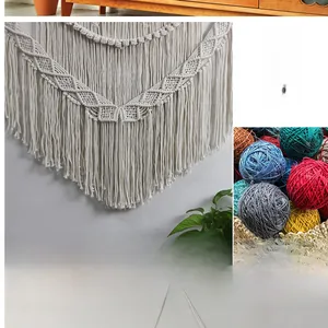 Detailed macro view of bohemian hand-woven beige cotton tapestry with long tassels